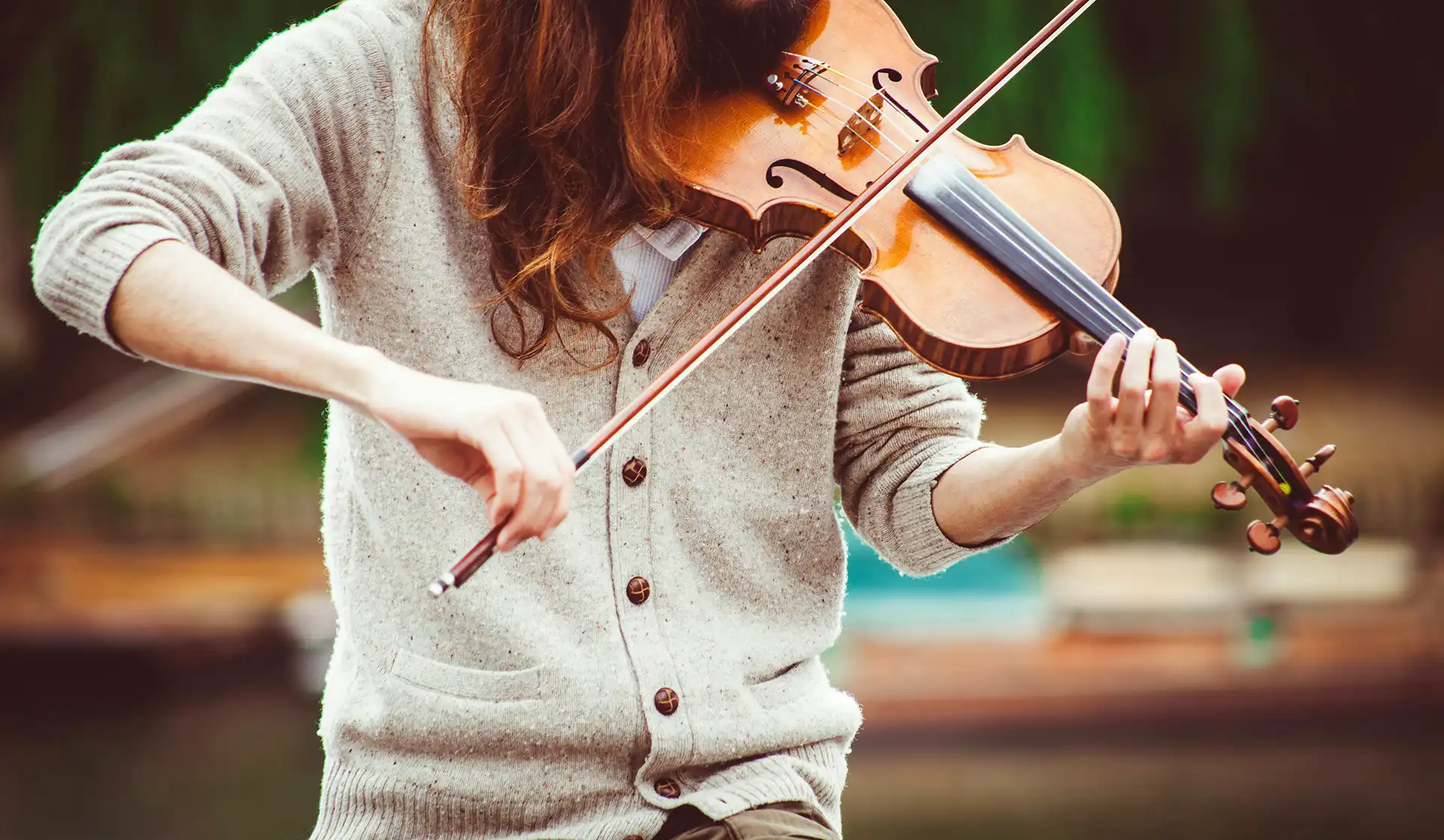 A violin resting on a wooden floor